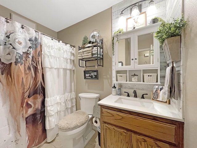 bathroom featuring tile patterned floors, vanity, and toilet