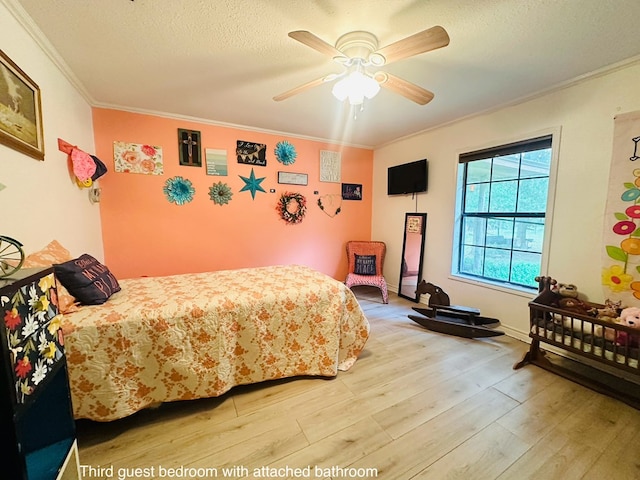 785 County Road 105, San Augustine, TX 75972 - bedroom featuring crown molding, a textured ceiling, ceiling fan, and light wood-style flooring