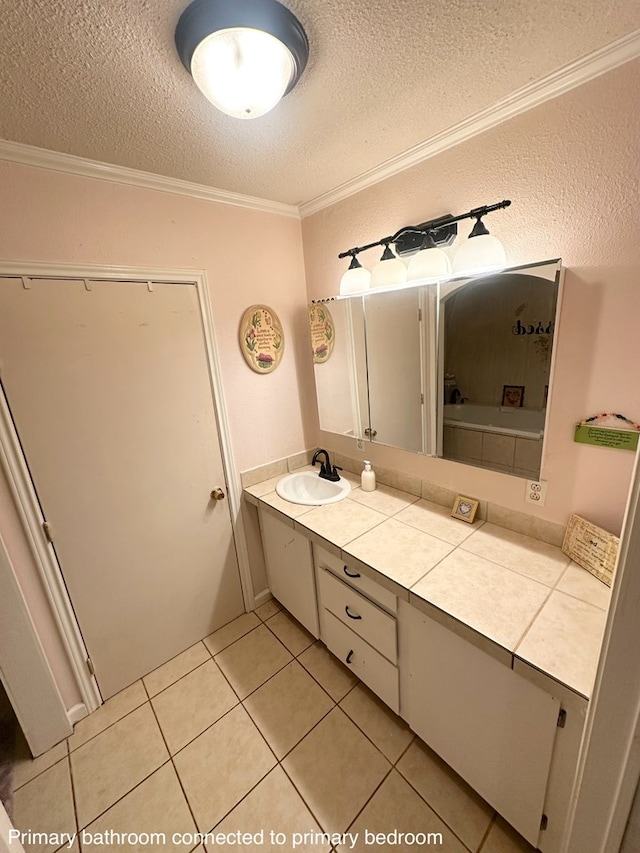 785 County Road 105, San Augustine, TX 75972 - bathroom featuring vanity, ornamental molding, tile patterned flooring, and a textured ceiling