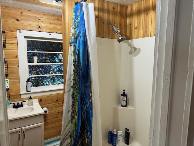 bathroom featuring wooden walls, a shower with shower curtain, and vanity