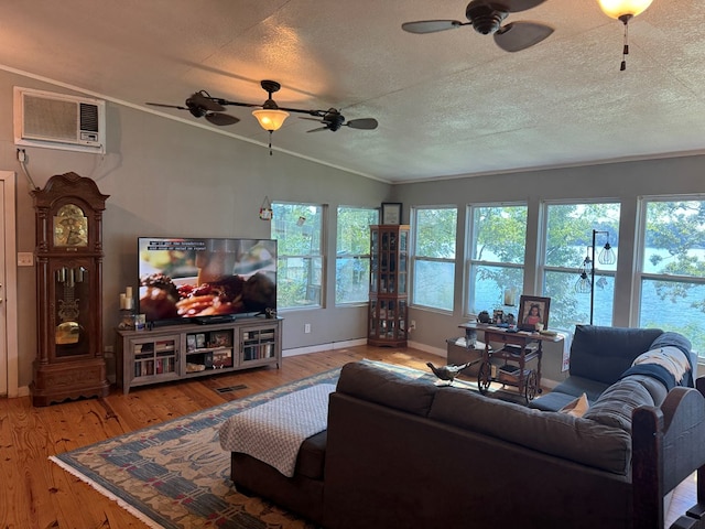 living area featuring crown molding, wood-type flooring, a wall mounted AC, vaulted ceiling, and a textured ceiling