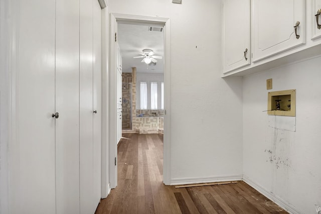 laundry area with dark hardwood / wood-style flooring, ceiling fan, cabinets, and hookup for a washing machine