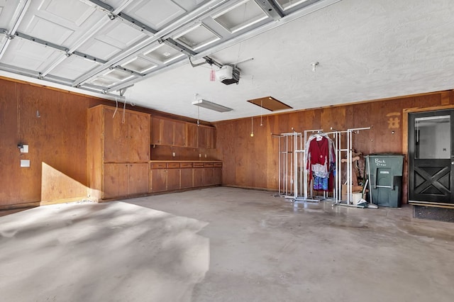 garage featuring wood walls and a garage door opener