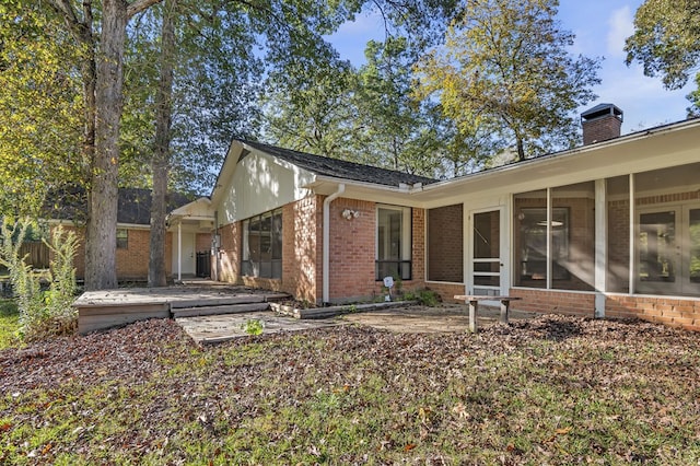 back of house featuring a sunroom and a patio area