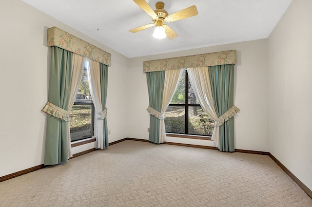 empty room with carpet flooring and ceiling fan