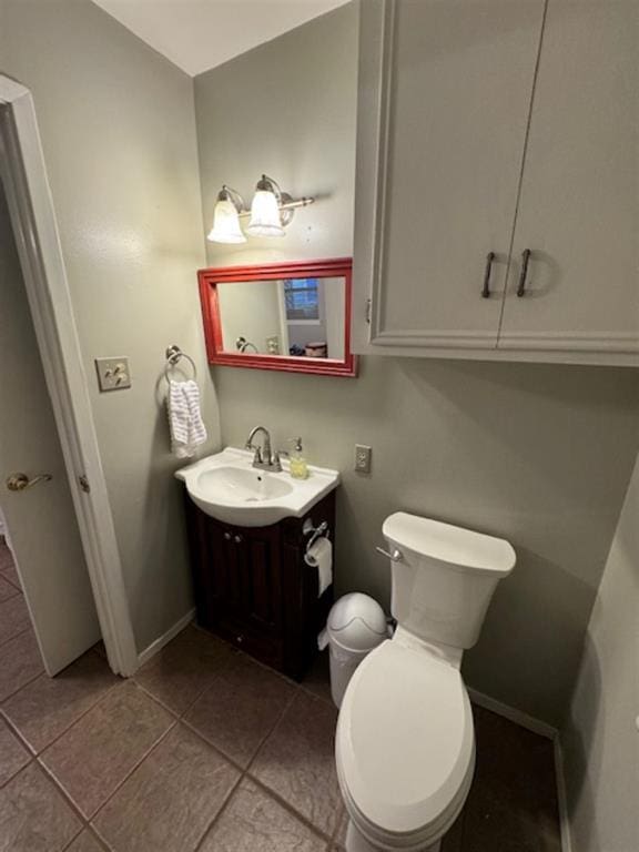 bathroom featuring tile patterned floors, vanity, and toilet