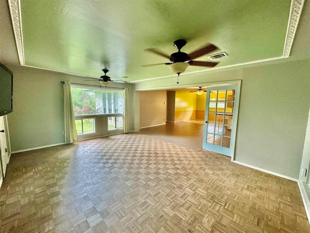 unfurnished living room with a textured ceiling and light parquet floors