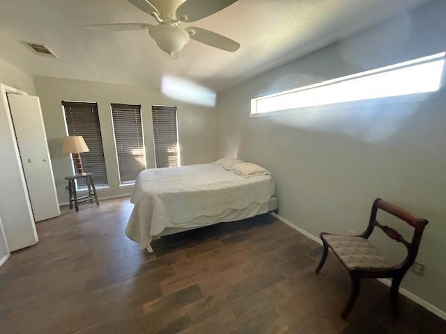 bedroom with dark hardwood / wood-style floors, ceiling fan, and lofted ceiling