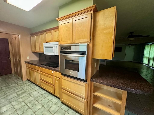 kitchen with ceiling fan, black electric stovetop, oven, and light brown cabinets