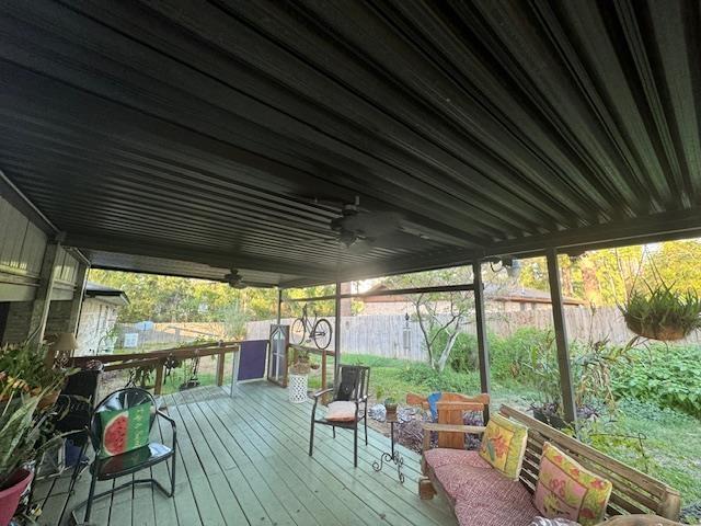 wooden deck featuring ceiling fan