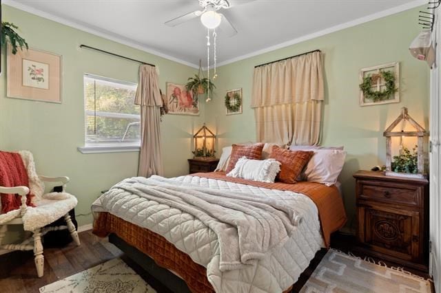 bedroom with ceiling fan, baseboards, ornamental molding, and wood finished floors