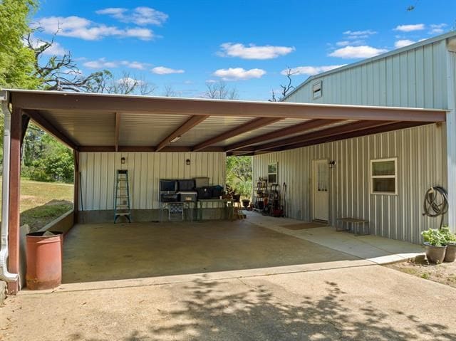 view of patio / terrace featuring driveway and a carport