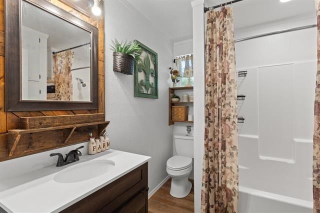 full bath featuring toilet, vanity, wood finished floors, and shower / bathtub combination with curtain