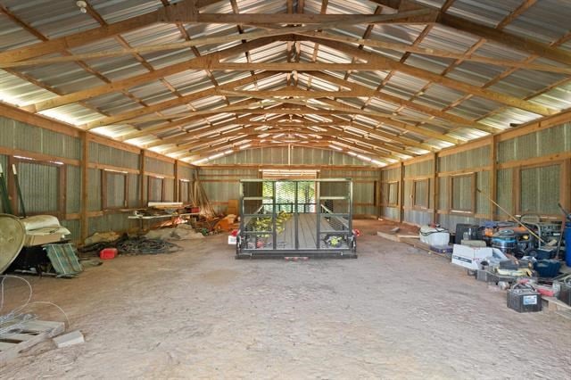 misc room featuring vaulted ceiling and metal wall