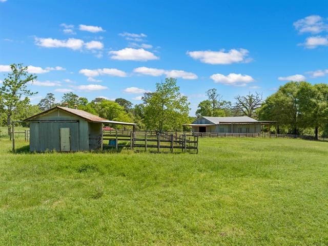 view of yard with an outdoor structure and fence
