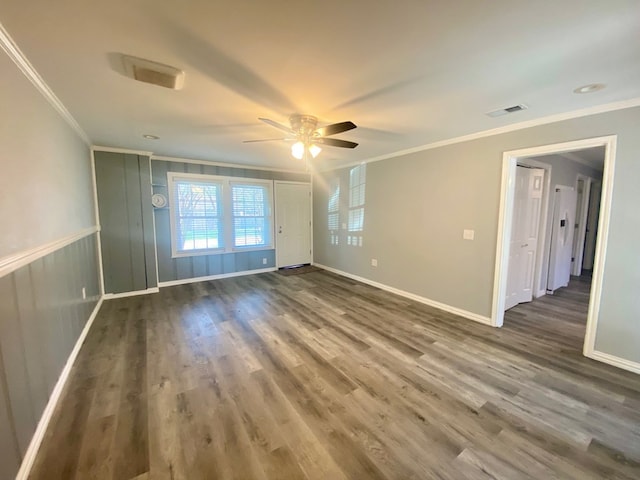 unfurnished room with hardwood / wood-style floors, ceiling fan, and crown molding