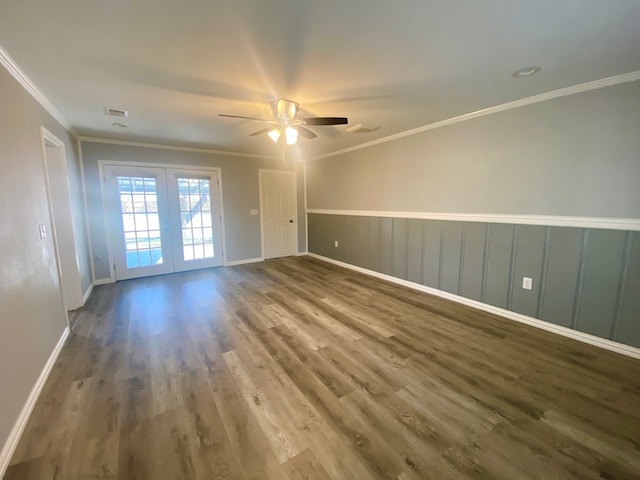 empty room featuring ceiling fan, wood-type flooring, ornamental molding, and french doors