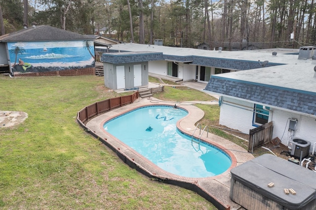 view of swimming pool with a yard and central AC