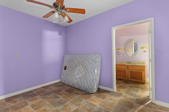 bedroom featuring ceiling fan and sink