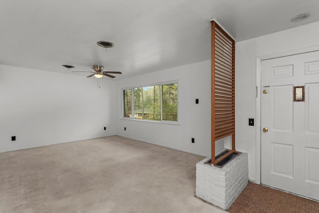 carpeted foyer entrance with ceiling fan