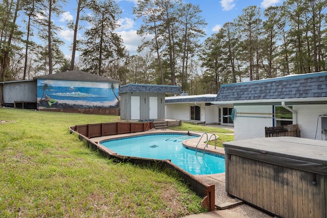 view of pool with a yard, a hot tub, and a storage unit