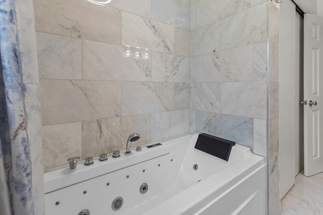 bathroom featuring tile walls and a tub