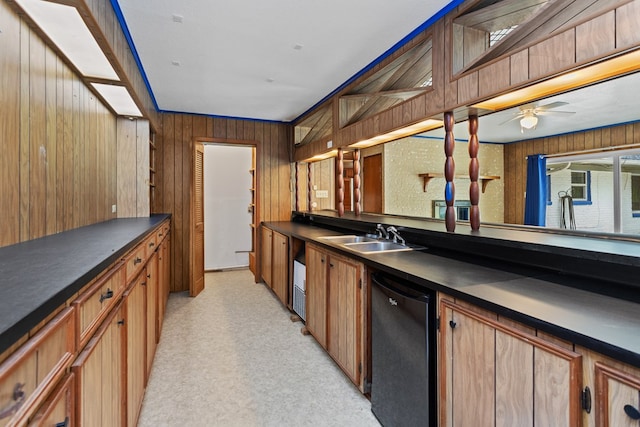 bar featuring ceiling fan, sink, light carpet, black dishwasher, and wooden walls