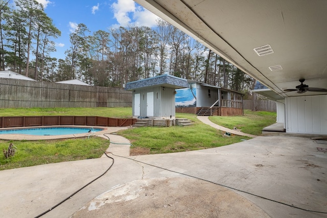 view of patio / terrace featuring a fenced in pool and ceiling fan