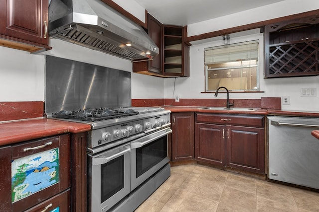 kitchen with sink, wall chimney range hood, and appliances with stainless steel finishes