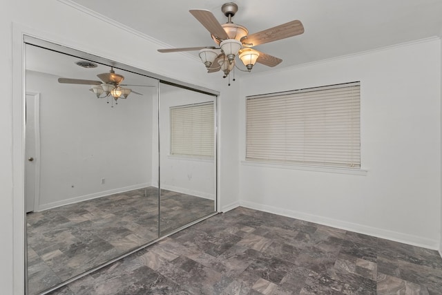 unfurnished bedroom with ceiling fan, a closet, and ornamental molding