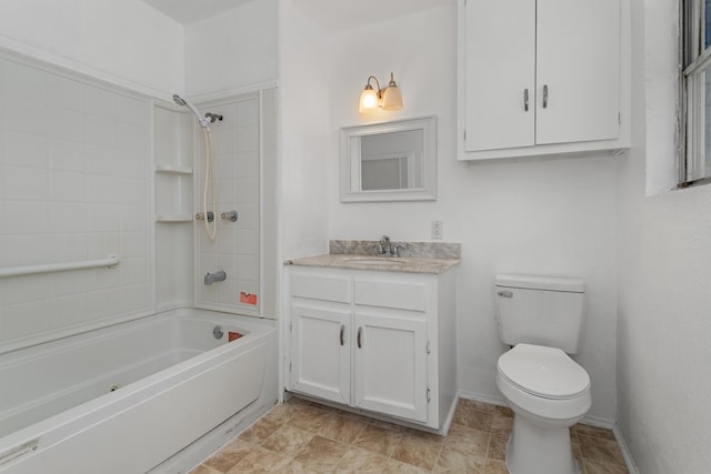 full bathroom featuring vanity, tiled shower / bath combo, and toilet