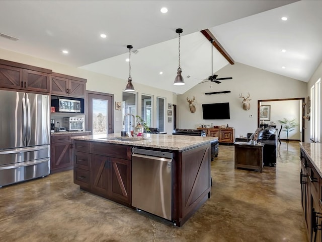 kitchen featuring concrete flooring, decorative light fixtures, visible vents, appliances with stainless steel finishes, and a center island with sink