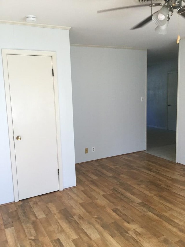 spare room with hardwood / wood-style floors and ceiling fan