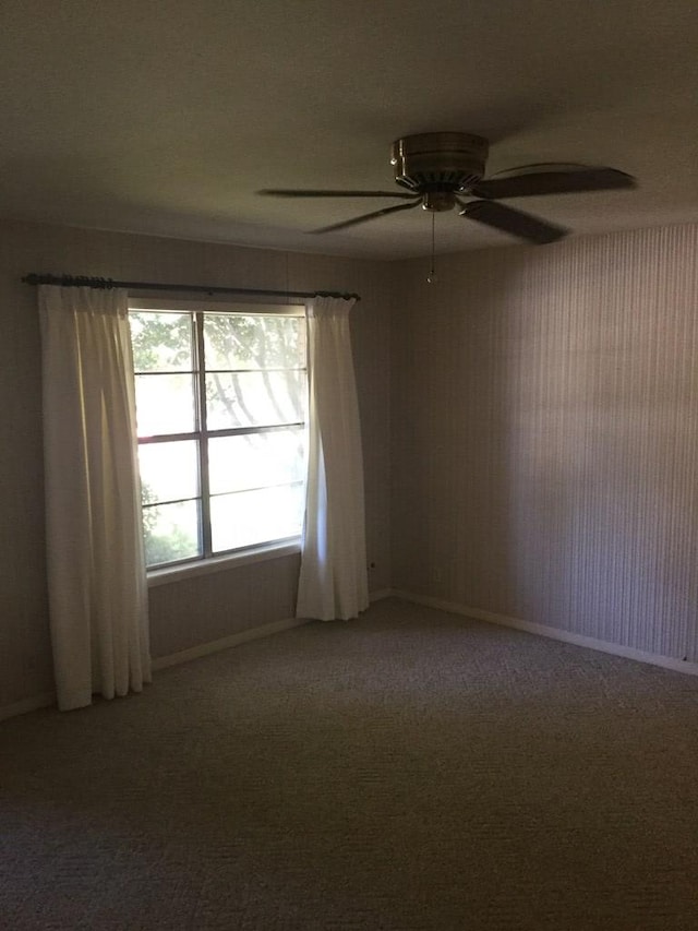 unfurnished room with carpet floors and ceiling fan