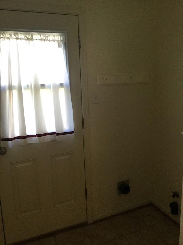 doorway featuring tile patterned flooring