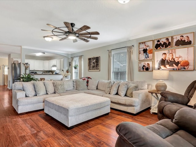 living room featuring dark wood-style floors, ceiling fan, and crown molding