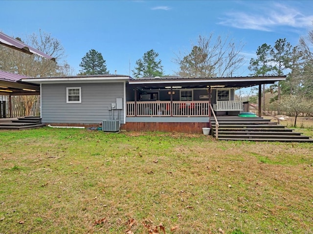 view of front of home featuring central air condition unit, metal roof, and a front yard