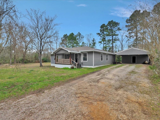 ranch-style home with dirt driveway, a front lawn, and covered porch