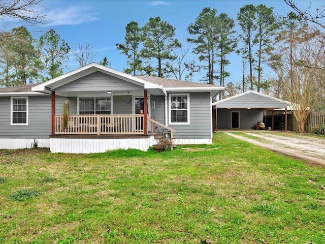 view of front of house featuring dirt driveway, a carport, a porch, and a front yard