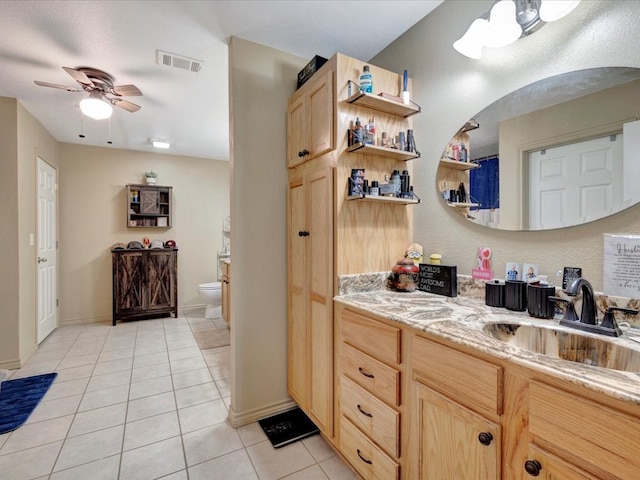 kitchen with open shelves, visible vents, light brown cabinetry, light tile patterned flooring, and a sink