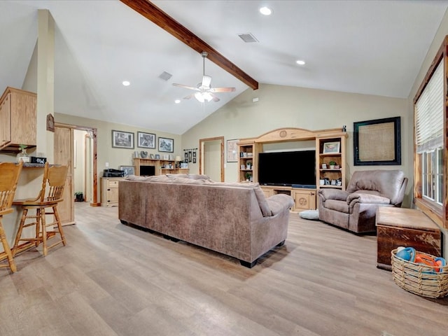 living area featuring ceiling fan, beamed ceiling, visible vents, and light wood-style floors