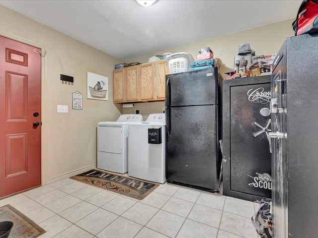 laundry room featuring cabinet space, a textured ceiling, washing machine and clothes dryer, and light tile patterned flooring