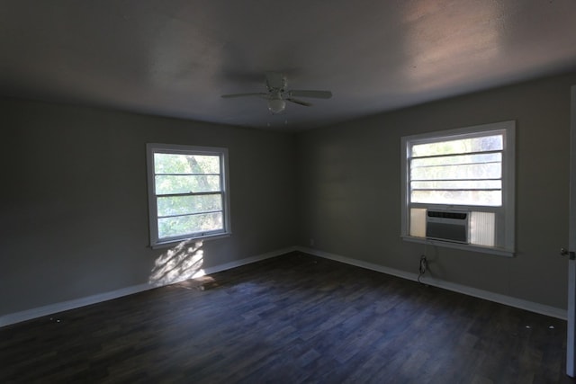 spare room featuring dark hardwood / wood-style flooring, a wealth of natural light, and ceiling fan