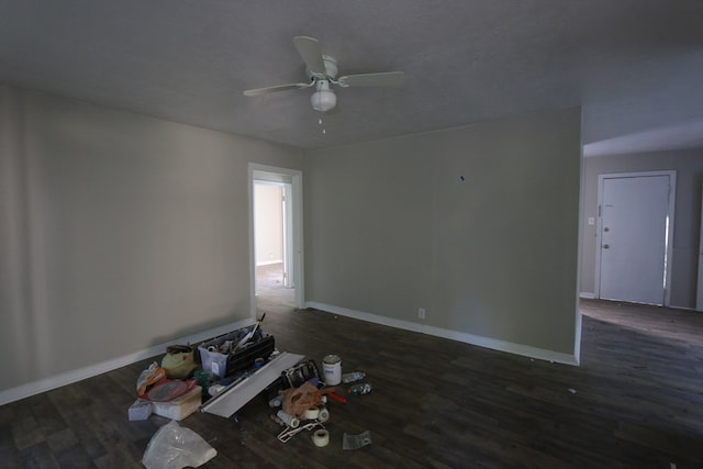 unfurnished room featuring ceiling fan and dark wood-type flooring