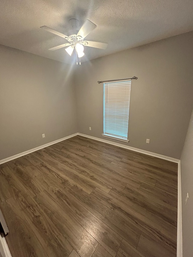 283 Dogwood Rd, Brookeland, TX 75931 - empty room with dark wood finished floors, ceiling fan, baseboards, and a textured ceiling