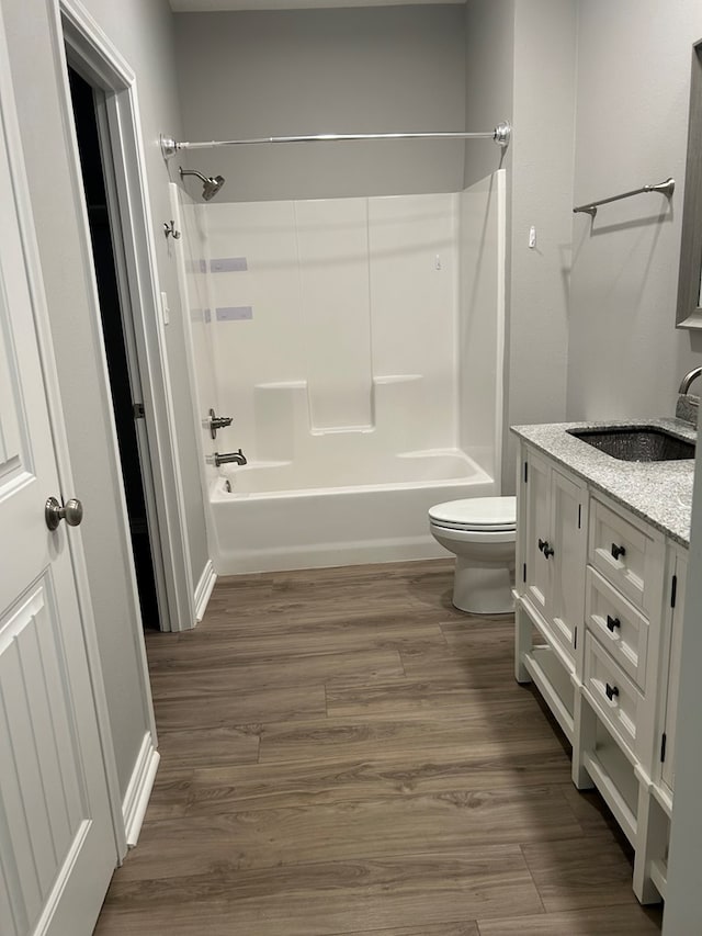 283 Dogwood Rd, Brookeland, TX 75931 - full bath featuring toilet, shower / washtub combination, vanity, and wood finished floors