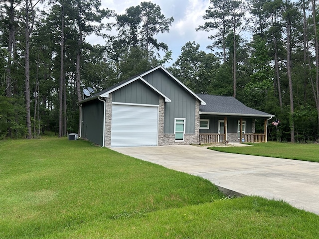 283 Dogwood Rd, Brookeland, TX 75931 - view of front of home featuring a porch, driveway, board and batten siding, stone siding, and a front yard