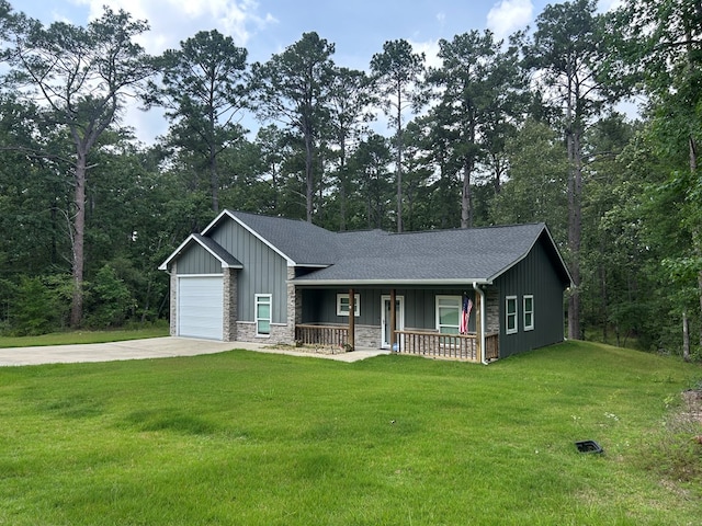 283 Dogwood Rd, Brookeland, TX 75931 - view of front facade with a porch, concrete driveway, board and batten siding, an attached garage, and a front yard