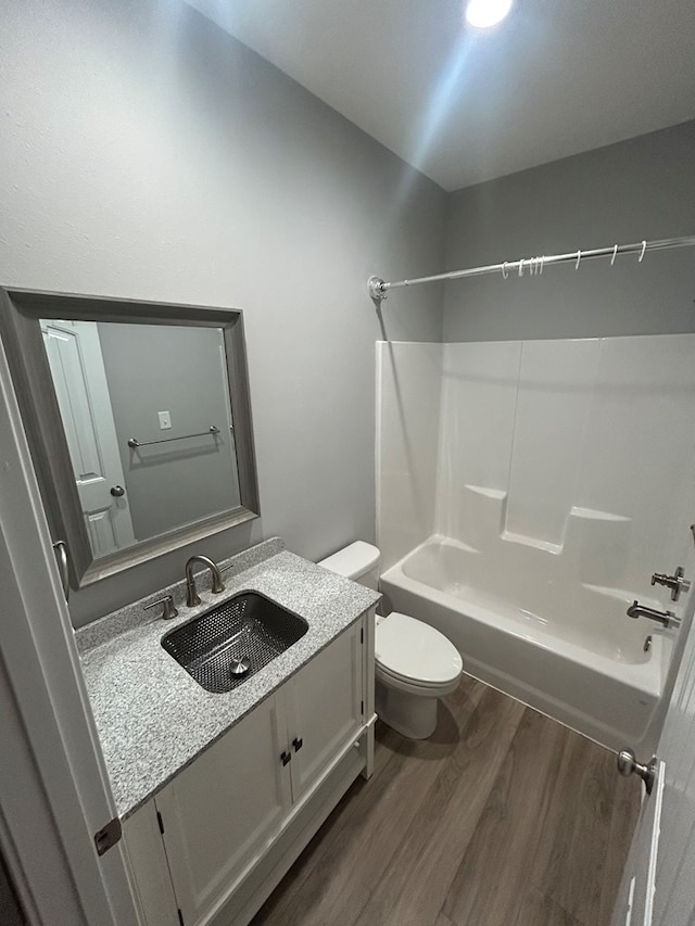 283 Dogwood Rd, Brookeland, TX 75931 - bathroom featuring wood finished floors, toilet,  shower combination, and vanity