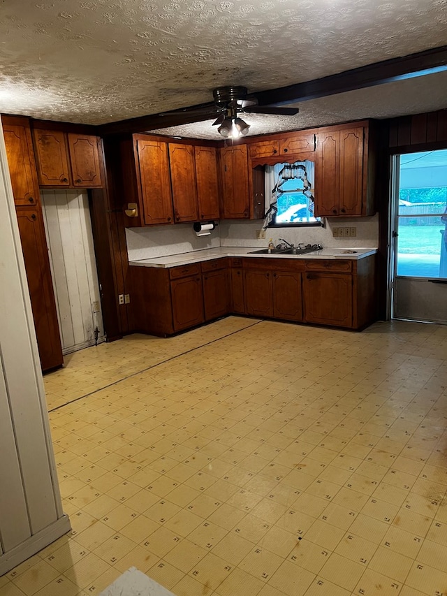 1418N Hendrix St, Diboll, TX 75941 - kitchen featuring light flooring, a ceiling fan, light countertops, and a textured ceiling